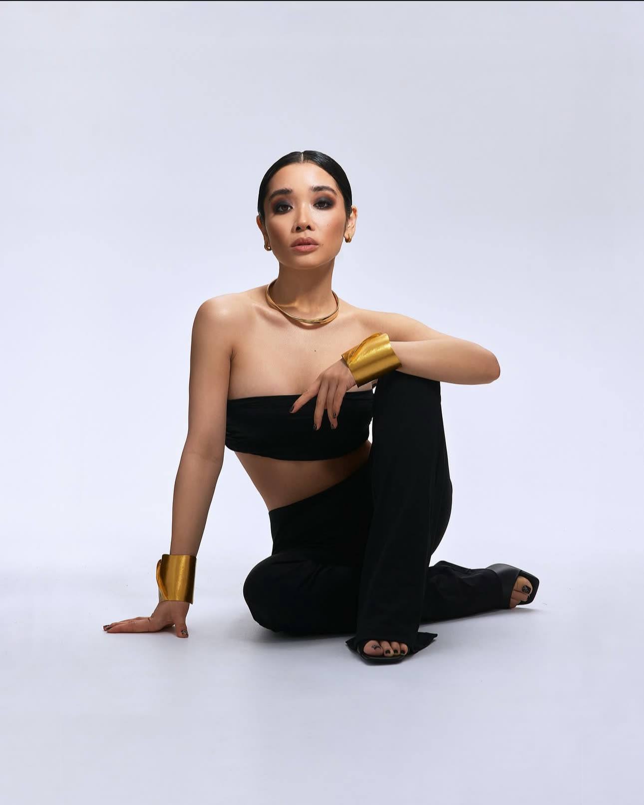 Model seated in a studio pose