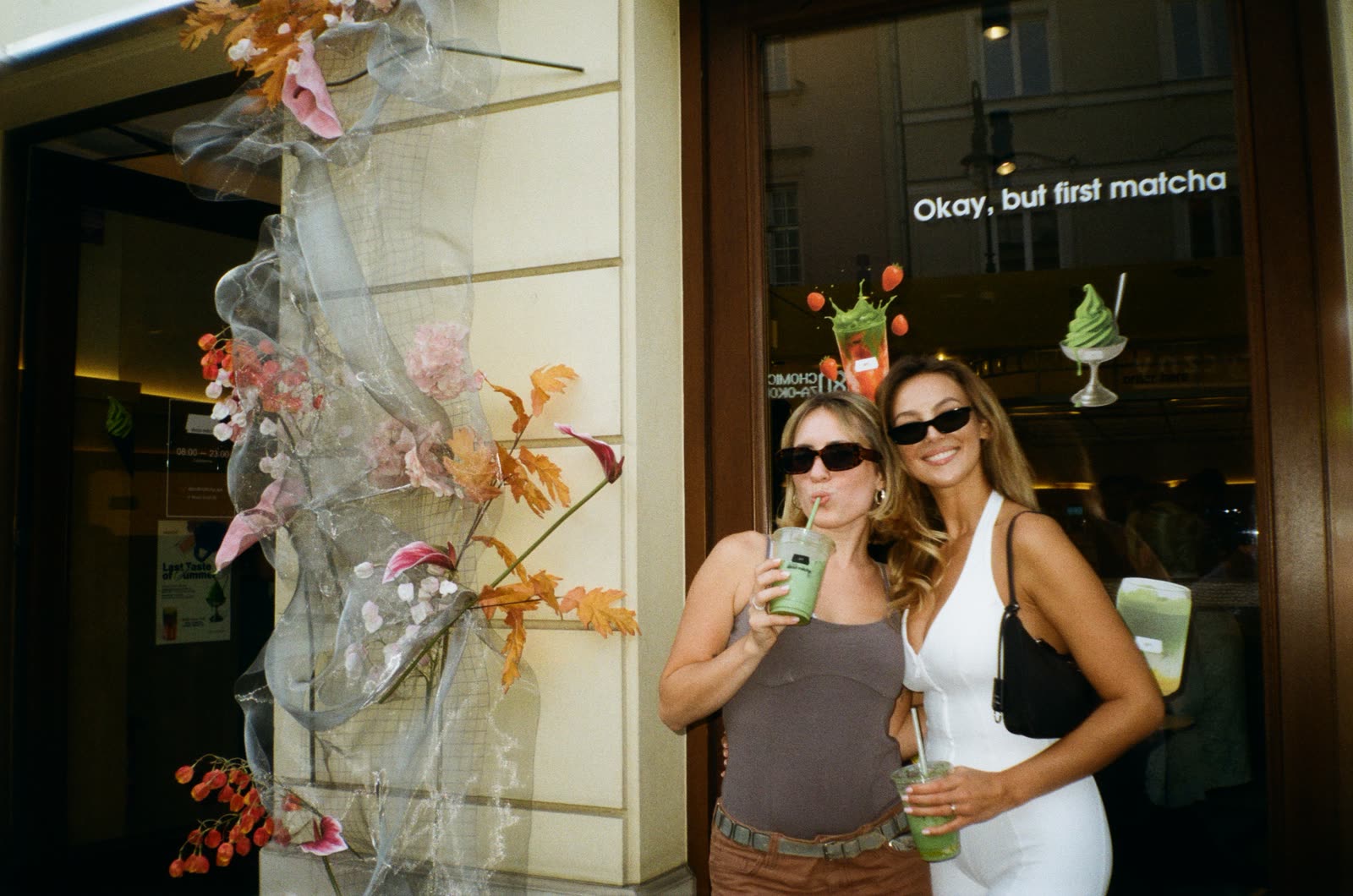 Two guests with matcha drinks at the entrance