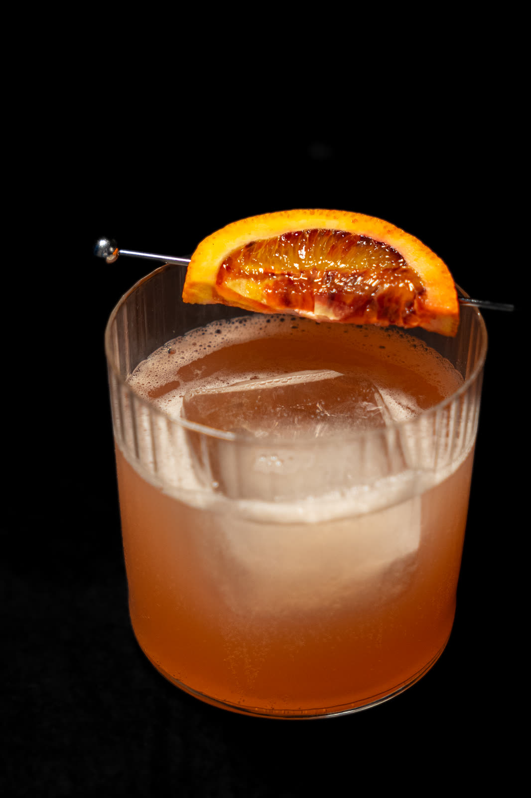 Blood-orange cocktail on a dark background